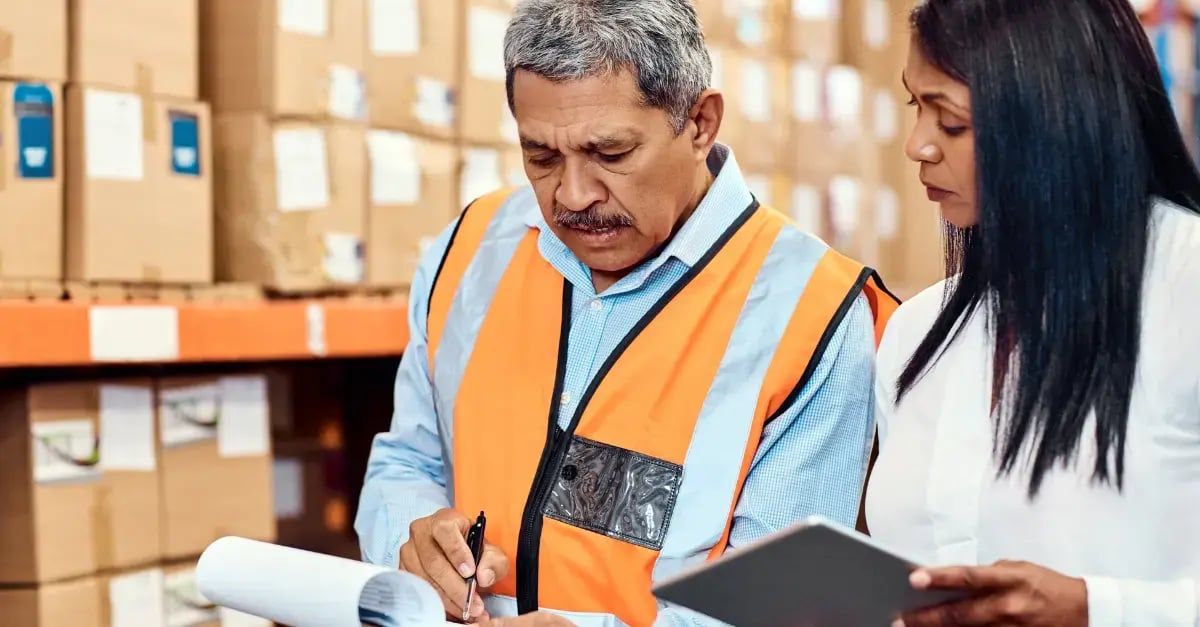 A warehouse manager using Protera's IT managed service during floor inspection