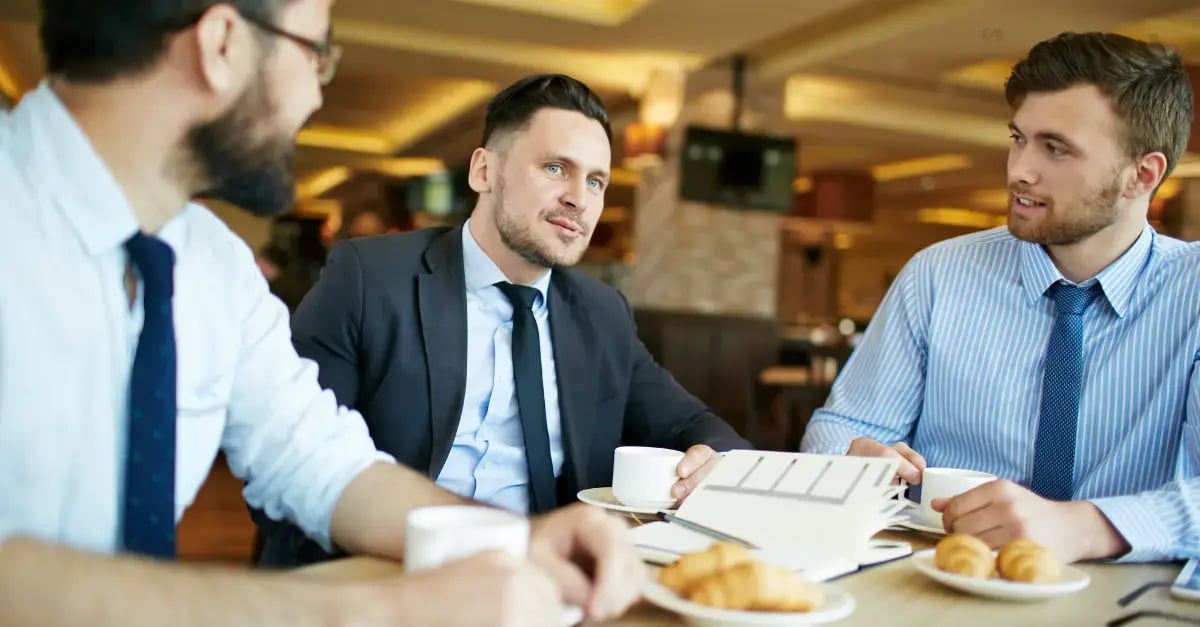 3 men on a business lunch discussing partnership for their sap consulting firm